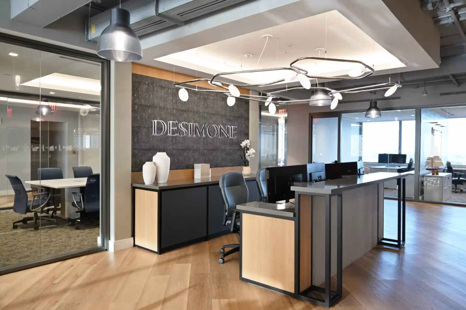 DeSimone Office interior designed by ODP, with a sculptural reception desk and warm lighting